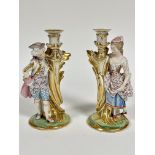 A pair of 19thc Continental porcelain figure candlesticks of a Lady and Gentleman in 18thc style