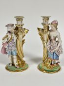 A pair of 19thc Continental porcelain figure candlesticks of a Lady and Gentleman in 18thc style