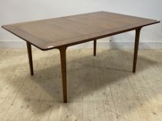 Mcintosh, A mid century teak extending dining table, the pull out top opening to two magic leaves,