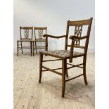 A pair of Edwardian inlaid mahogany and satin birch bedroom chairs, with upholstered seats raised on