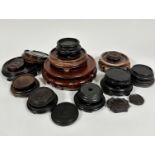 A collection of twenty various hardwood and ebonised stands and a ceramic stand, (largest d 22cm,