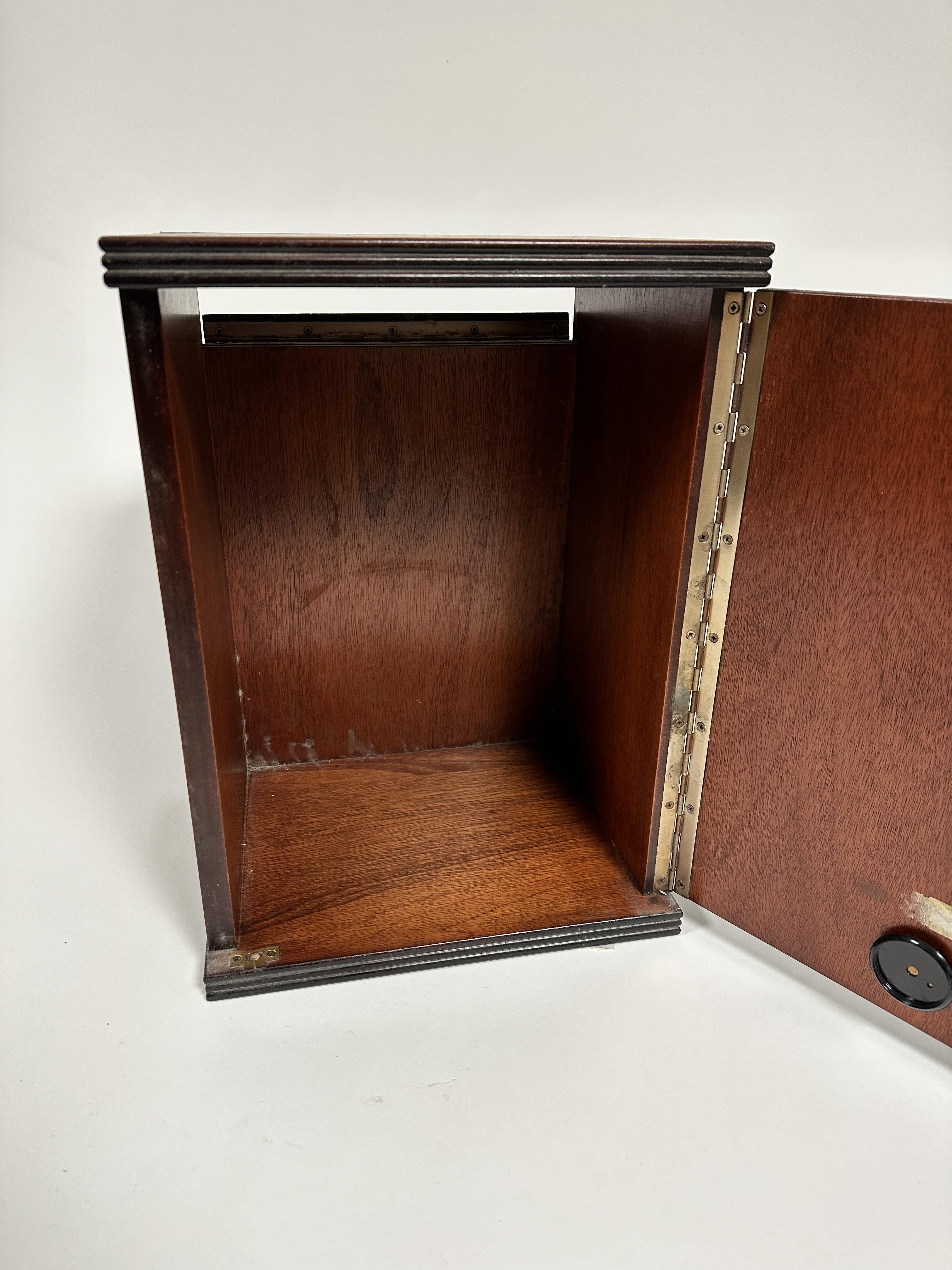 A mahogany cabinet, the rectangular top with reeded edge, above a hinged panel door enclosing a - Image 2 of 2