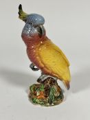 A Beswick pottery figure of a cockatoo decorated with polychrome enamels on moulded base,