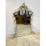 A parcel gilt composition framed Rococo style over mantel mirror, the frame of 'C' scrolled acanthus
