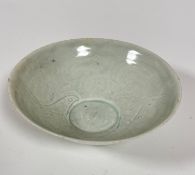 A Chinese Qing style celadon glazed bowl decorated with stylised fish and scrolling wave interior