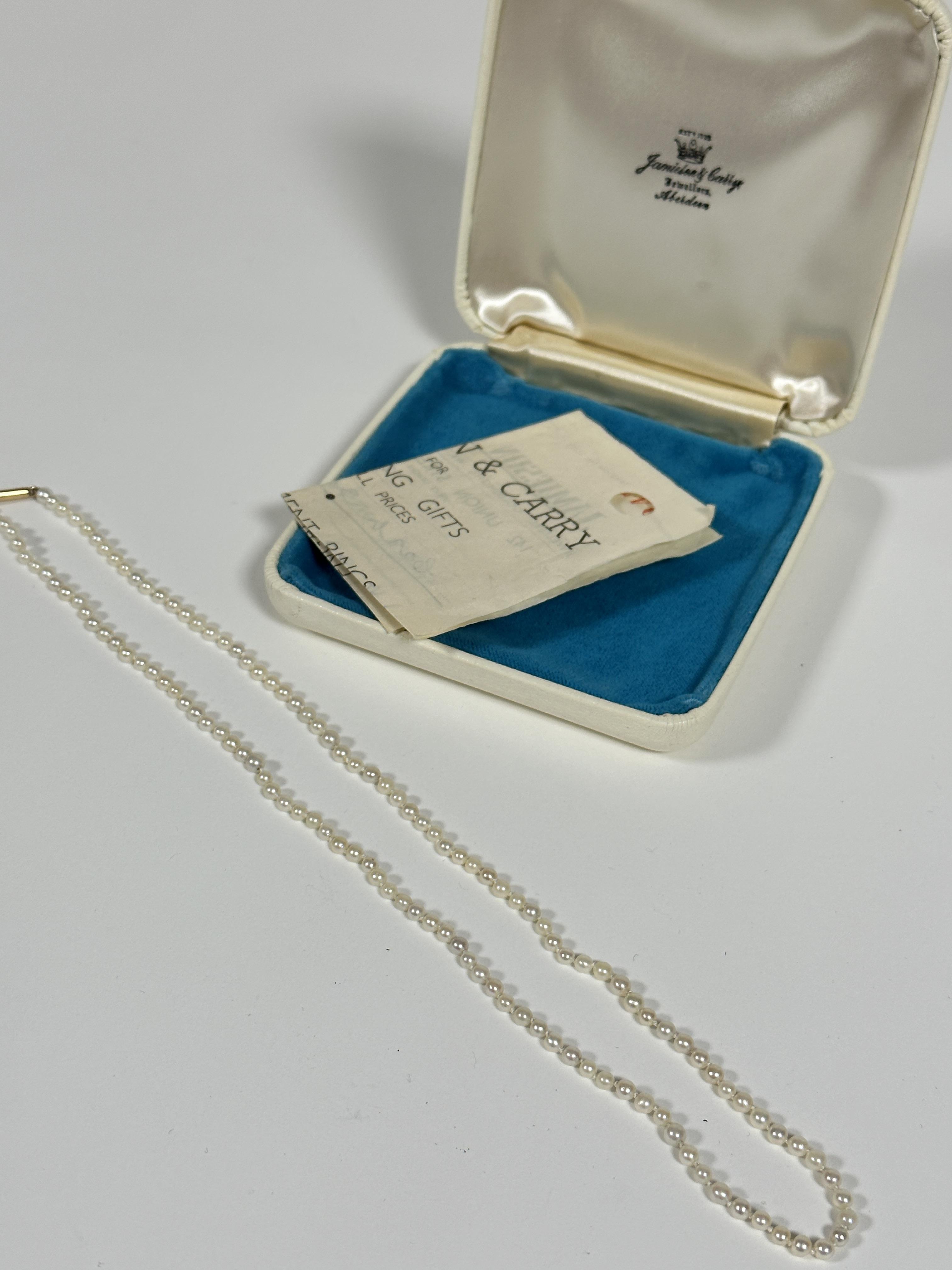 A graduated cultured pearl necklace with 9ct gold barrel fastening, (L:24cm) with original