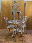A white painted cast aluminium garden suite of Coalbrookdale design, comprising a table with