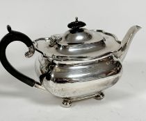 A Sheffield silver oval teapot with scalloped top and ebony handle and knop, with engraved