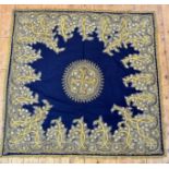 A Kashmiri felted table cover, the center lotus flowers enclosed within shaped panel with pale