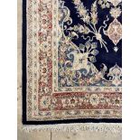 A wool pile ground rug, the blue field with ivory medallion and border 263cm x 156cm