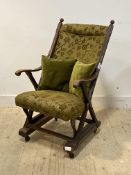 A late 19th century mahogany 'X' framed open armchair, moving on castors, H102cm, W57cm, D64cm
