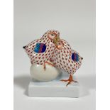 A Herend porcelain pair of Chicks with an egg in a orange pattern with gilt beaks and claws. ( h