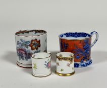 A collection of various tea cups, one decorated with blue and orange enamelling depicting floral