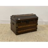 An early 20th century dome top trunk, with plain interior and carry handle to each end, H49cm,