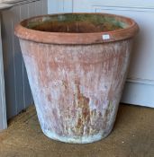 A large terracotta planter of tapered cylindrical outline, H70cm, D76cm