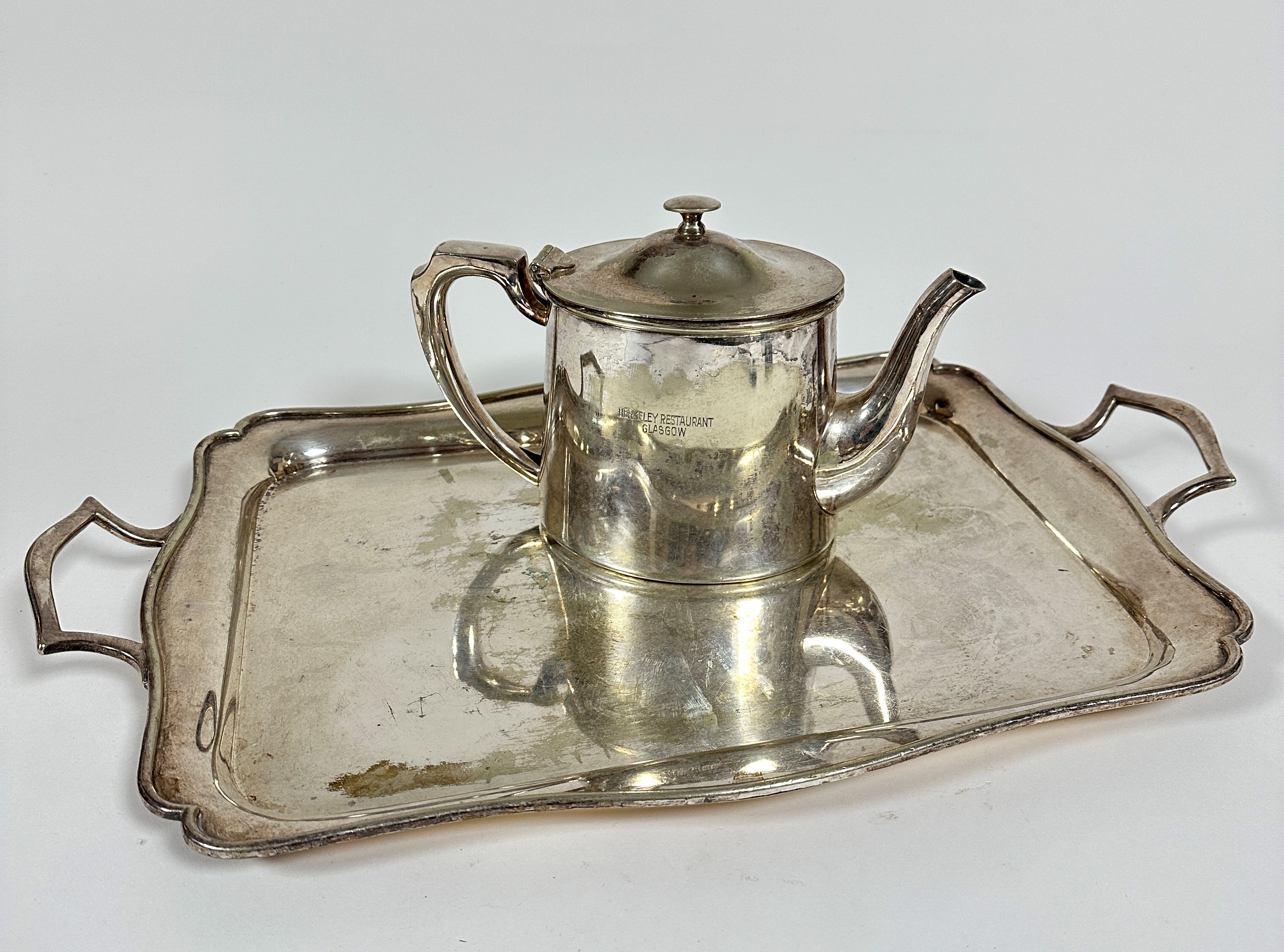 A Berkeley Restaurant Glasgow oval Epns teapot, (h 17cm x 14cm x 12cm) and an Epns scalloped two