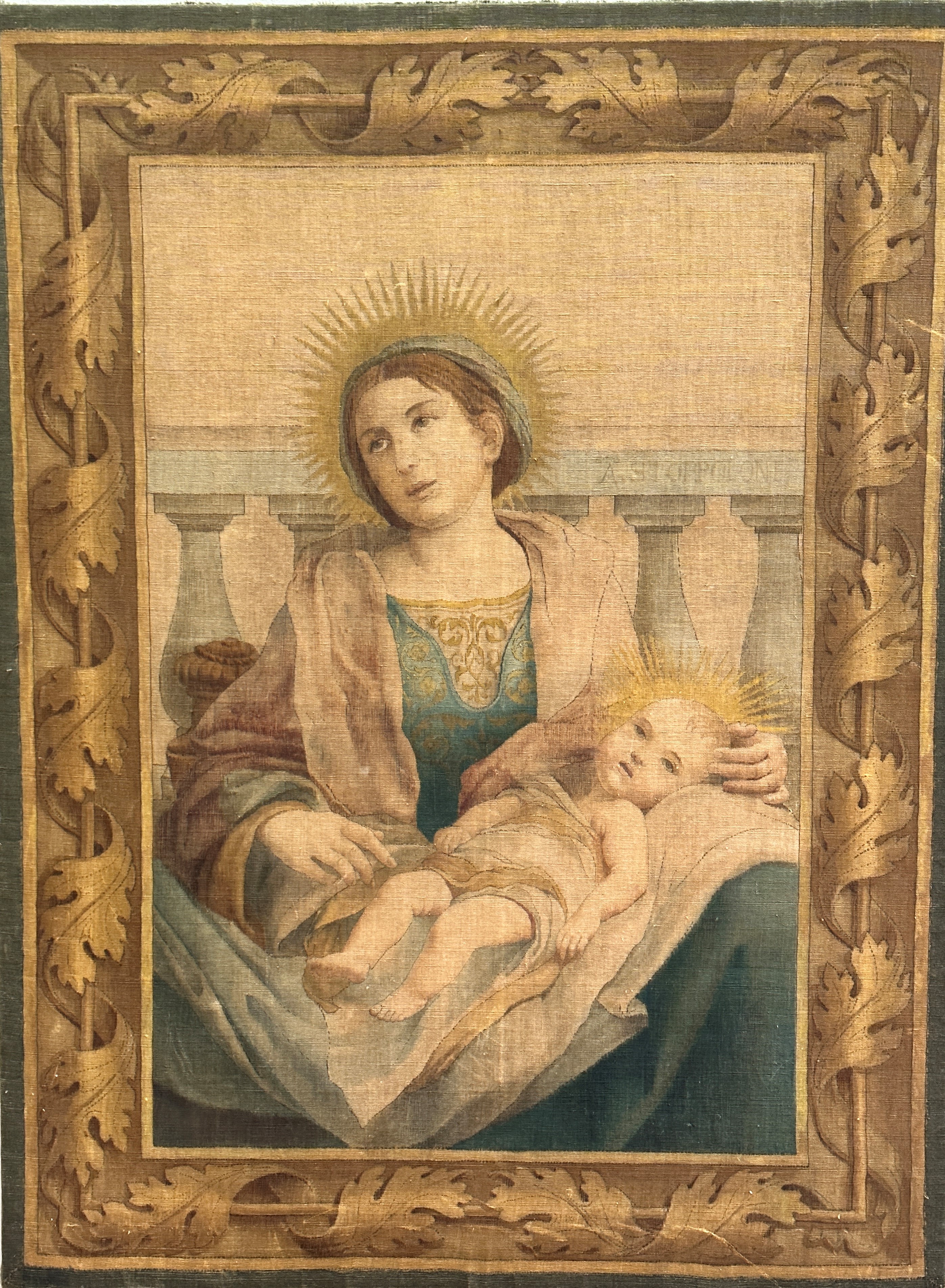 A late 19thc machine made panel depicting Madonna and infant Jesus in her lap, inscribed on