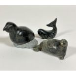 An Inuit soap stone carving of a seal on its side, signed Jacob E, (5cm x 10cm x 4cm) an Inuit