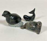 An Inuit soap stone carving of a seal on its side, signed Jacob E, (5cm x 10cm x 4cm) an Inuit