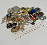 A collection of costume jewellery including an amethyst coloured paste set oval brooch, an