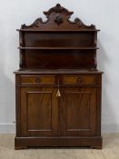 A mid 19th century mahogany chiffonier, the raised back with two open shelves on scrolled supports