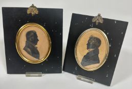 Two 19thc silhouette portrait miniatures on coloured paper in oval gilt metal mounted black
