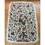 A Kashmiri felted natural wool rug with fringed border with hand embroidered tree with three