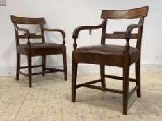A good pair of late George III mahogany elbow chairs, each with carved rail back, down swept and