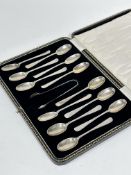 A set of twelve silver Old English pattern tea spoons complete with tongs, in original fitted
