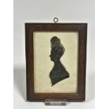A Regency style silhouette portrait miniature highlighted with gilt to lace and hair, in oak