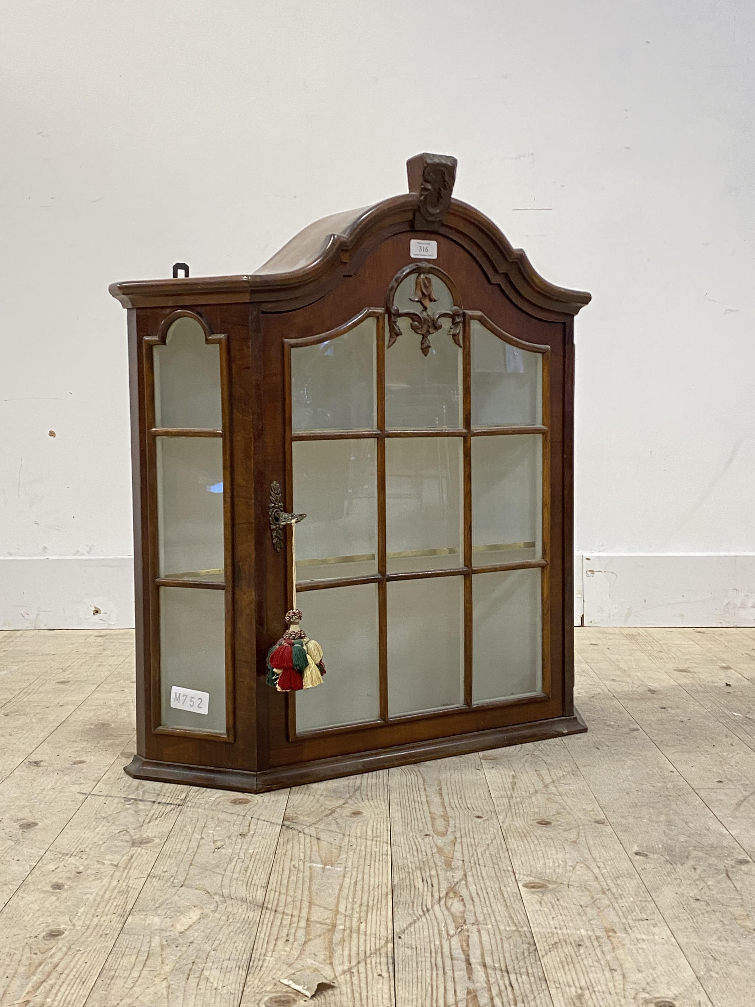 A glazed walnut wall hanging display cabinet, with two shelves to interior, H73cm