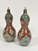 A pair of Japanese porcelain double gourd shaped vases decorated with tobacco leaf and chrysanthemum