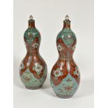 A pair of Japanese porcelain double gourd shaped vases decorated with tobacco leaf and chrysanthemum