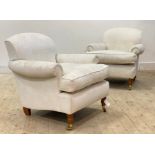 A pair of Victorian style easy chairs, upholstered in floral ivory damask fabric, raised on turned