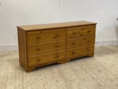 A polished pine sideboard, fitted with six drawer, on bracket supports, H72cm, W151cm, D41cm