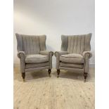 A pair of Harris Tweed barrel back armchairs, upholstered in grey wool with leather piping, raised