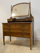An Edwardian inlaid mahogany dressing chest, the top with swing mirror over two trinket drawers, the