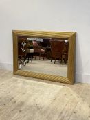 A gilt framed wall mirror, the bevelled plate engraved with a tulip, 76cm x 109cm