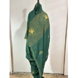 An Indian green crepe de chine silk Sari with gilt wire worked scrolling panel, lotus flowers to