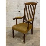 A Victorian mahogany open armchair, the rail back over upholstered seat and arm rests with