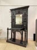 An impressive late Victorian oak hall stand, the back with multiple panels carved with foliate and