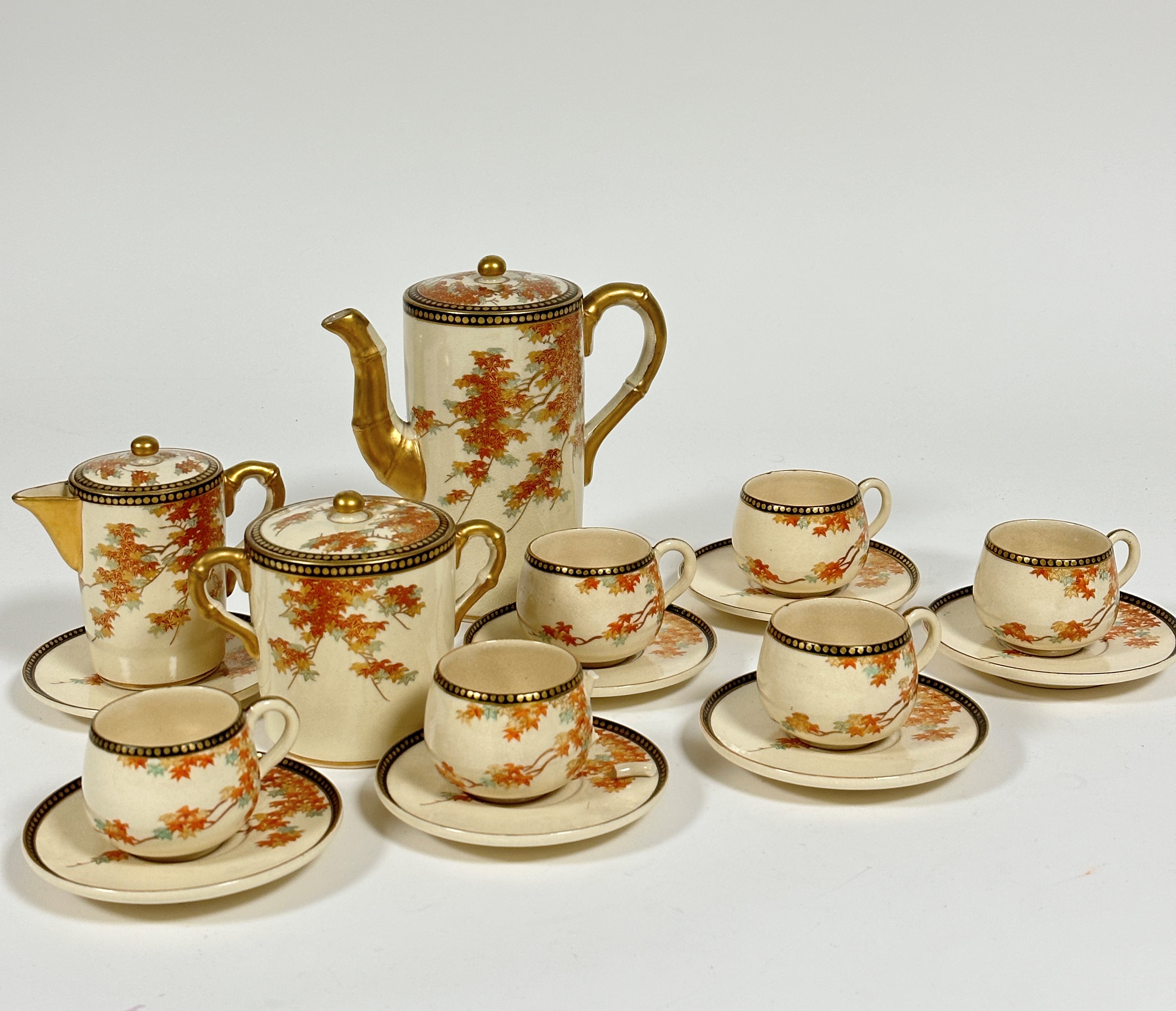 A Japanese satsuma sixteen piece coffee set including six coffee cans of baluster form, and seven