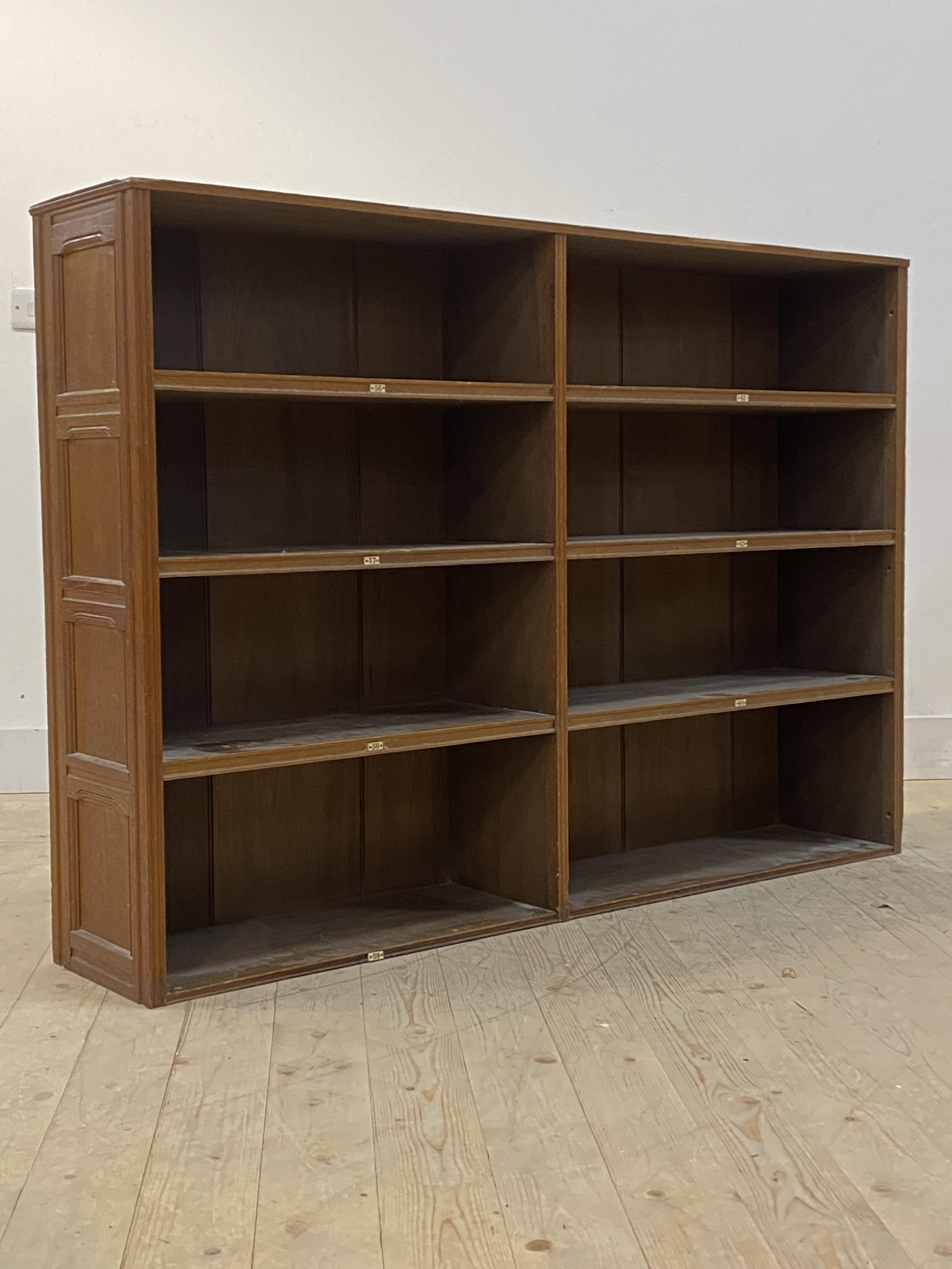 An Edwardian stained oak bookcase, with six shelves, panels to one side (formerly one section out of