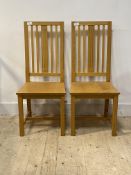 A pair of contemporary oak dining chairs, H105cm, W45cm, D44cm