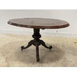 A Victorian mahogany loo table, the oval top on baluster column and three splayed supports moving on