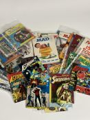 A large collection of various comic books such as a few DC Superman, Strange tales of Suspense,