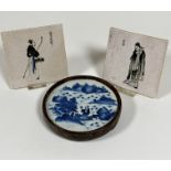 A pair of Japanese tiles depicting a figure with basket of flowers and a figure dressed in