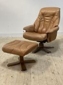 A reclining chair and footstool, upholstered in tan leather, by Soderbergs of Sweden
