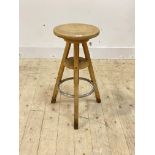 An artists easel stool, the circular rise and fall seat on three supports, H65cm