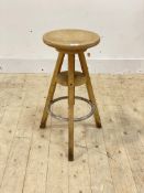 An artists easel stool, the circular rise and fall seat on three supports, H65cm
